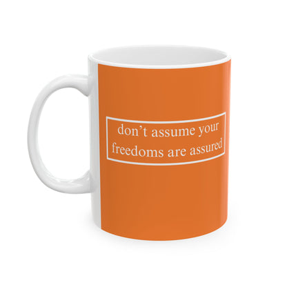 don't assume your freedoms are assured, White font, Orange/White Mug by cypherpunkgear.com