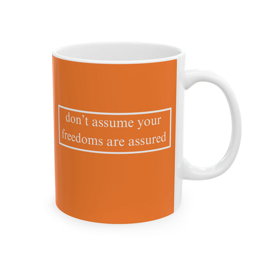 don't assume your freedoms are assured, White font, Orange/White Mug by cypherpunkgear.com