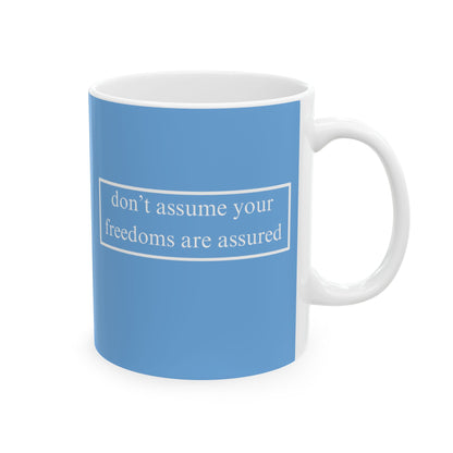 don't assume your freedoms are assured, White font, Light Blue/White Mug by cypherpunkgear.com
